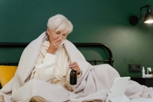 Older woman in the bed not feeling great