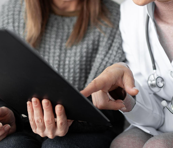 Doctor showing her patient results Doctor showing her patient results